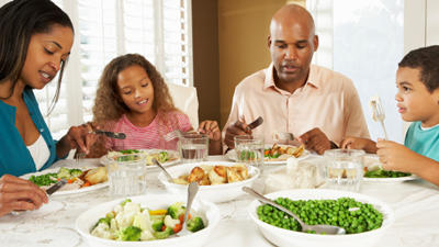 Family eating dinner together.