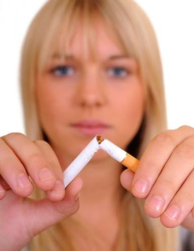 Female smoker breaking a cigarette