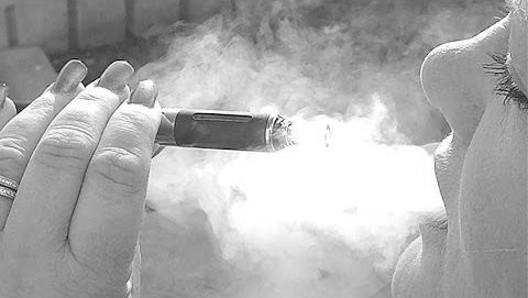 DrugAbuse.gov July 2015 image of a woman vaping an e-cigarette
