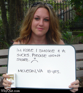 Eighteen year-old Kate, a Marlboro Light smoker, howing a sign which reads 'I smoke and it sucks.  Please don't start.