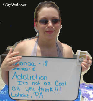 Rhonda, age 18, holding a sign that reads 'Addiction, it is not as cool as you think'