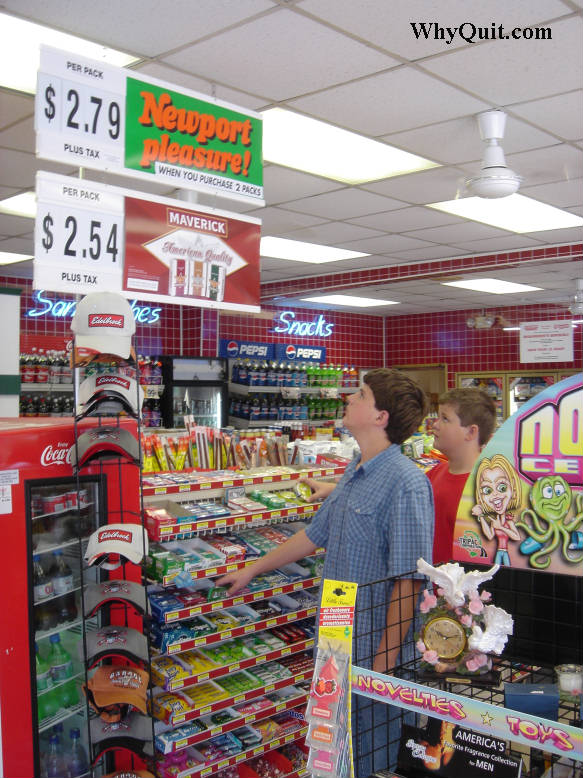 two boys eyeing cigarette advertising posters hanging above a convenience store candy rack