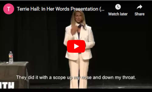 Terrie Hall standing on a stage during her 'In her own words' school presentation
