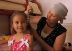Screenshot of Susan DeWitt brushing her youngest daughter's hair.