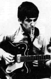 George Harrison of the Beatles smoking a cigarette while his guitar gently weeps