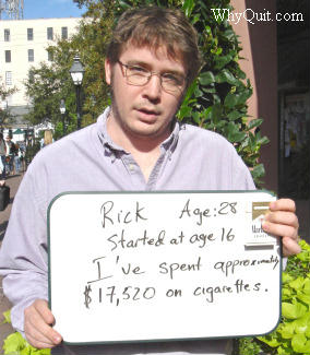 Rick holding a sign telling how much money he saved after he stopped smoking