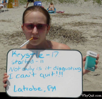 Photo of 17 year-old Krystle, a NewPort smoker who started smoking at age 11, holding a sign.  It reads, 'Not only is it disgusting, I can't quit!!!'