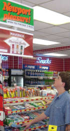 two brothers look at tobacco sign while at store gum racks