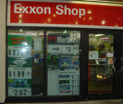 Exxon store windows filled with cigarette ads