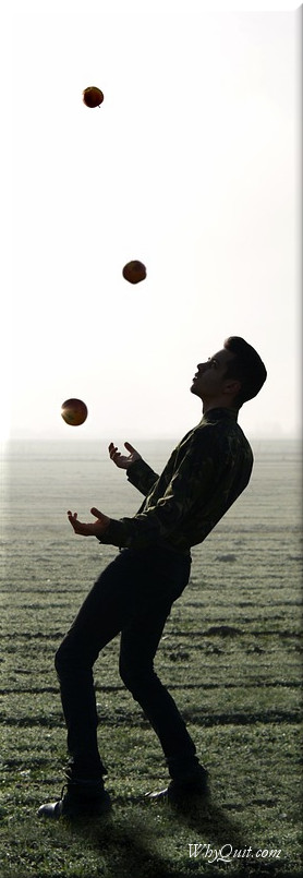 Man juggling in field
