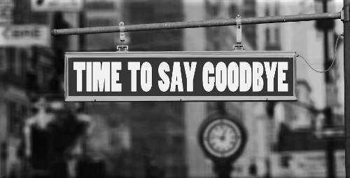 A streetsign that reads 'Time to Say Goodbye' with a clock in the background.
