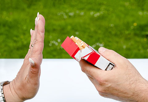 A person saying no to an offer of a cigarette