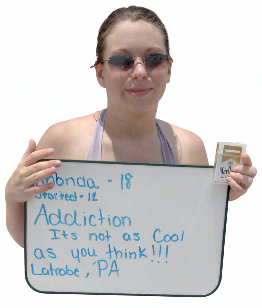 Rhonda, age 18, holding a sign that reads 'Addiction, it is not as cool as you think'