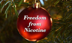 A red Christmas tree ornament captioned Freedom from Nicotine