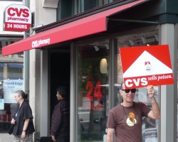 Photo of Dr. Gerace carrying his sign while protesting in front of CVS