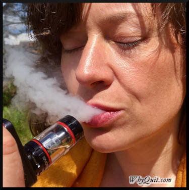 Woman with her eyes closed while vaping an e-cigarette