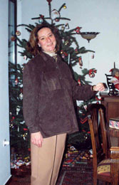 Photo of Noni in December 1998 smiling while standing in front of her Christmas tree