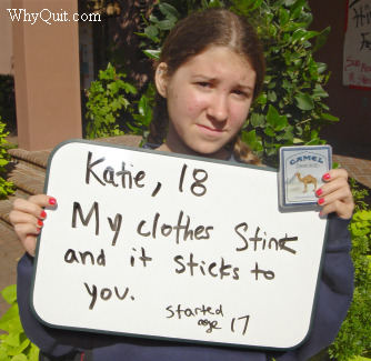 Photo showing 18 year-old Katie, a Camel smoker who became addicted at age 17, holding a sign. Her message reads, 'My clothes stink and it sticks to you.'